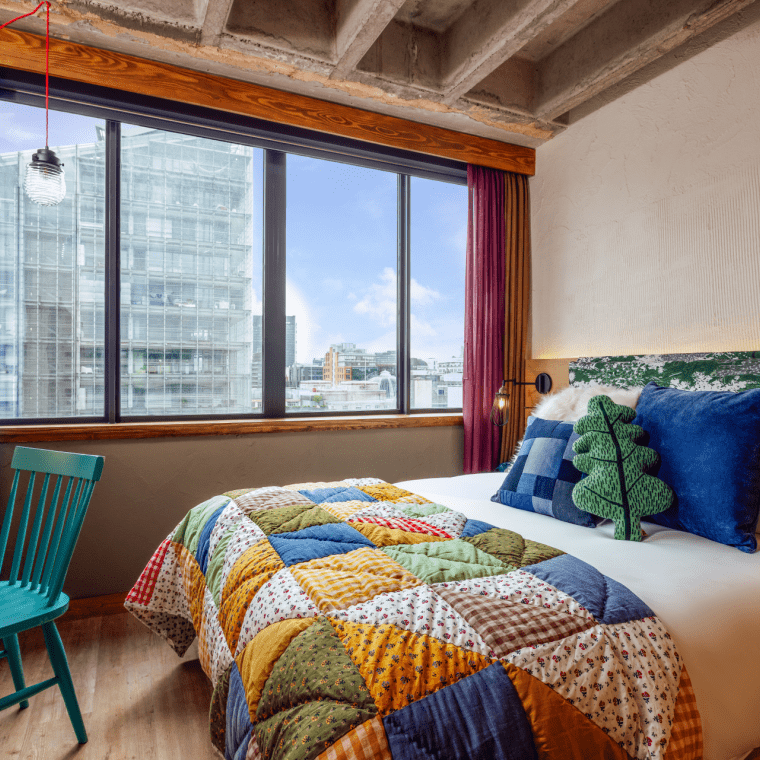 hotel room with king bed and view of skyline