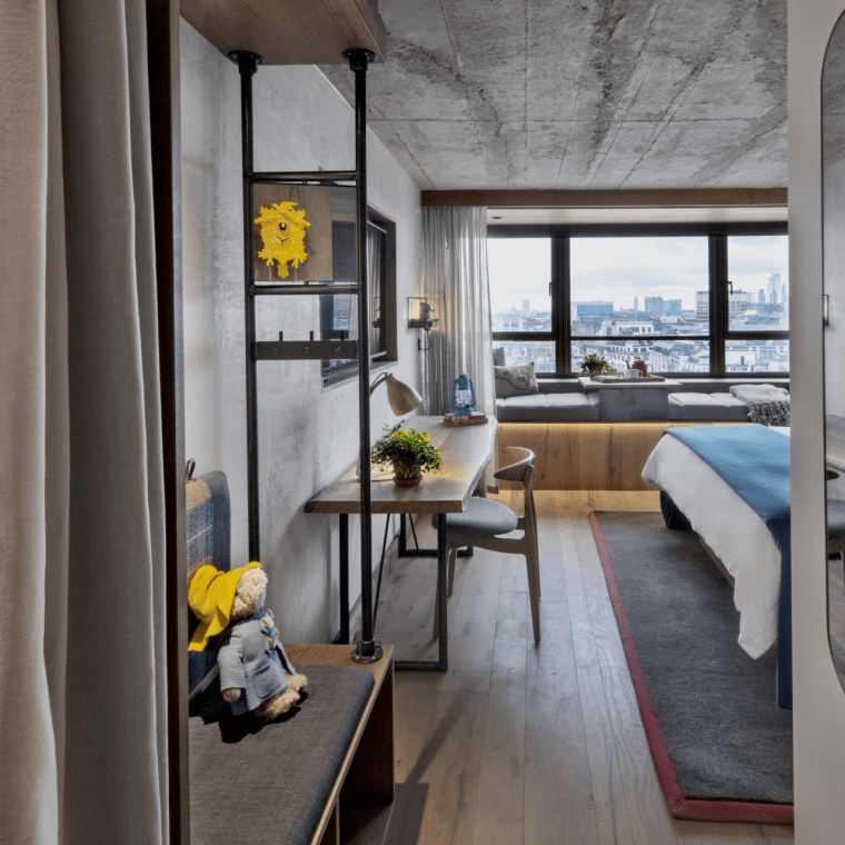 Entry way to hotel room with wardrobe and bench