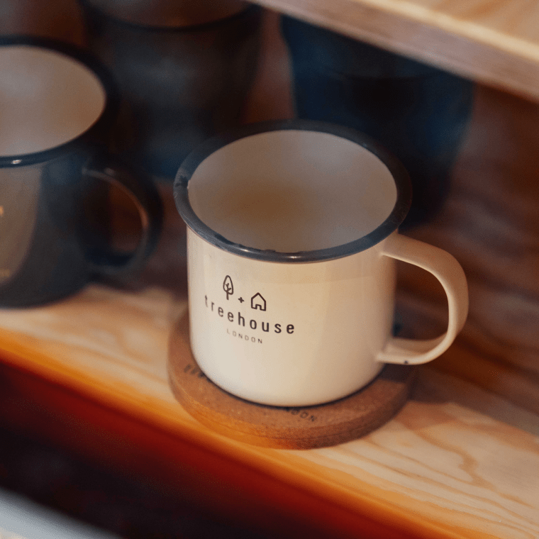 Treehouse Branded mugs on a shelf