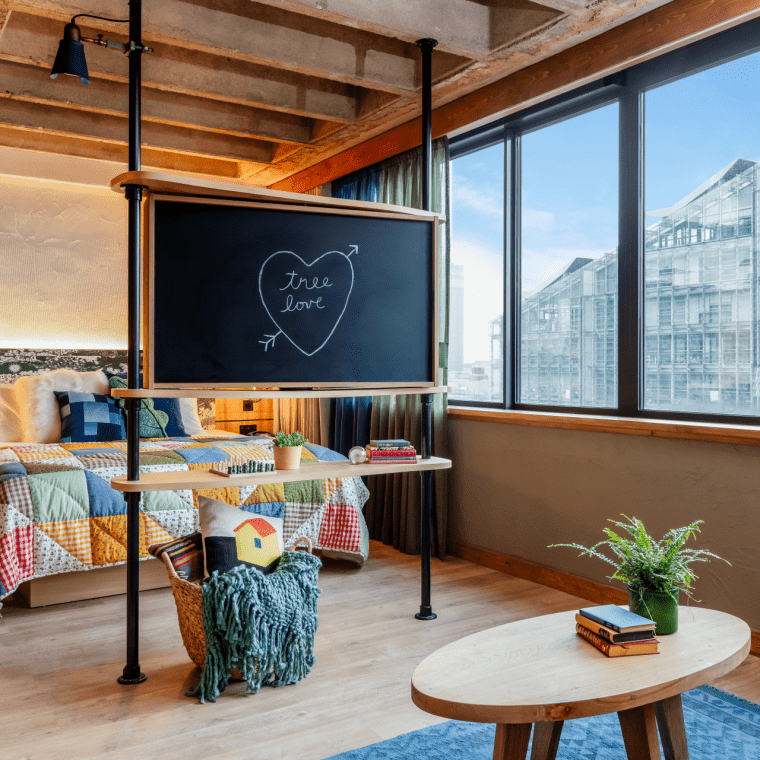 hotel room with bed and chalk board with Tree Love written in a heart