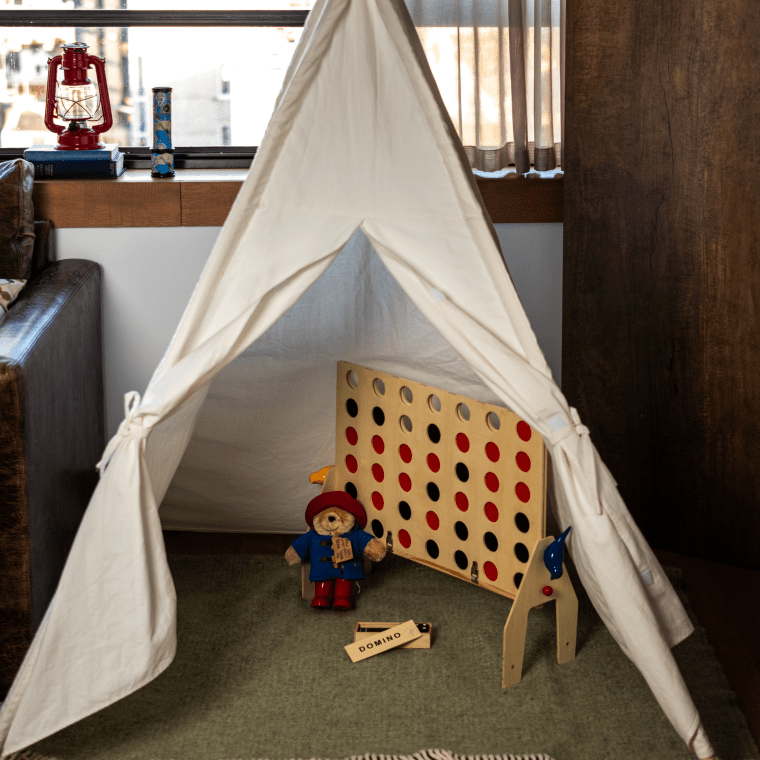 A children's tee-pee with connect four game set up inside at Treehouse Hotel.