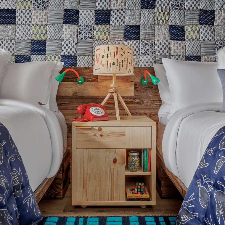 hotel room with two beds that share a nightside table