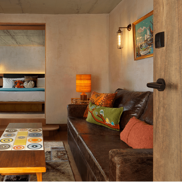 seating area with long table and wide doorway to bedroom