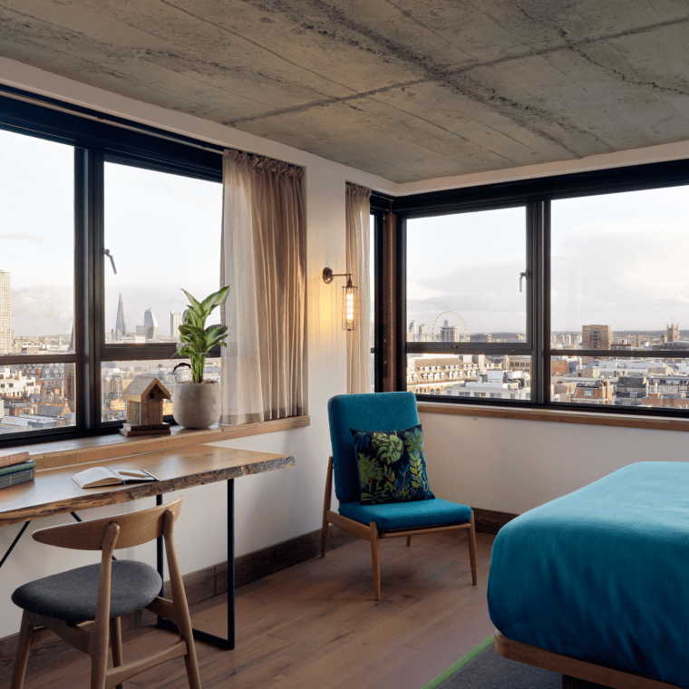 hotel room with workspace and small chair