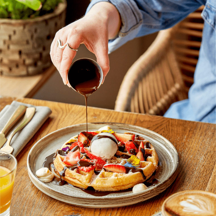Pouring syrup on waffles