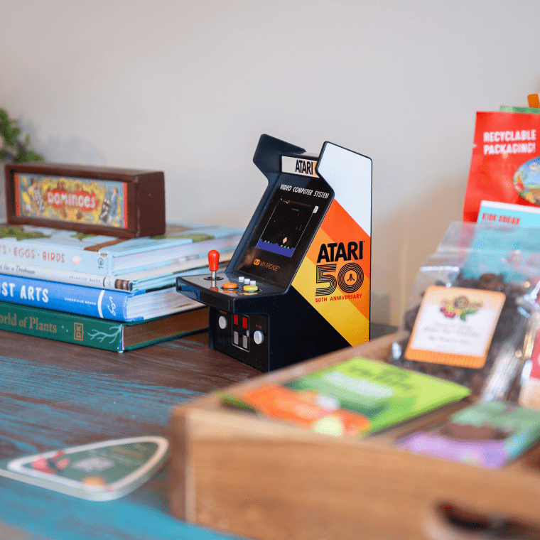 shelf with small arcade game and snack tray