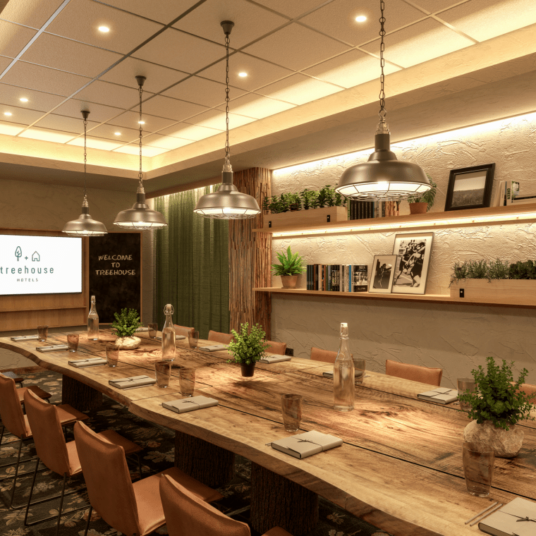 The Chestnut space at Treehouse Manchester, a warmly lit board room with greenery touches.