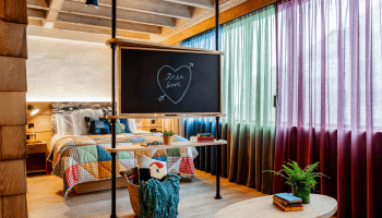 hotel room with bed and chalk board with Tree Love written in a heart