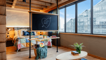 hotel room with bed and chalk board with Tree Love written in a heart