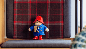 Paddington bear sitting on a bench