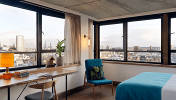 hotel room with workspace and small chair