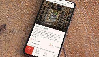Cell phone with the Treehouse Mobile App open on a wood table