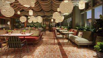 A cozy restaurant featuring a brick floor and an abundance of lush green plants throughout the space.