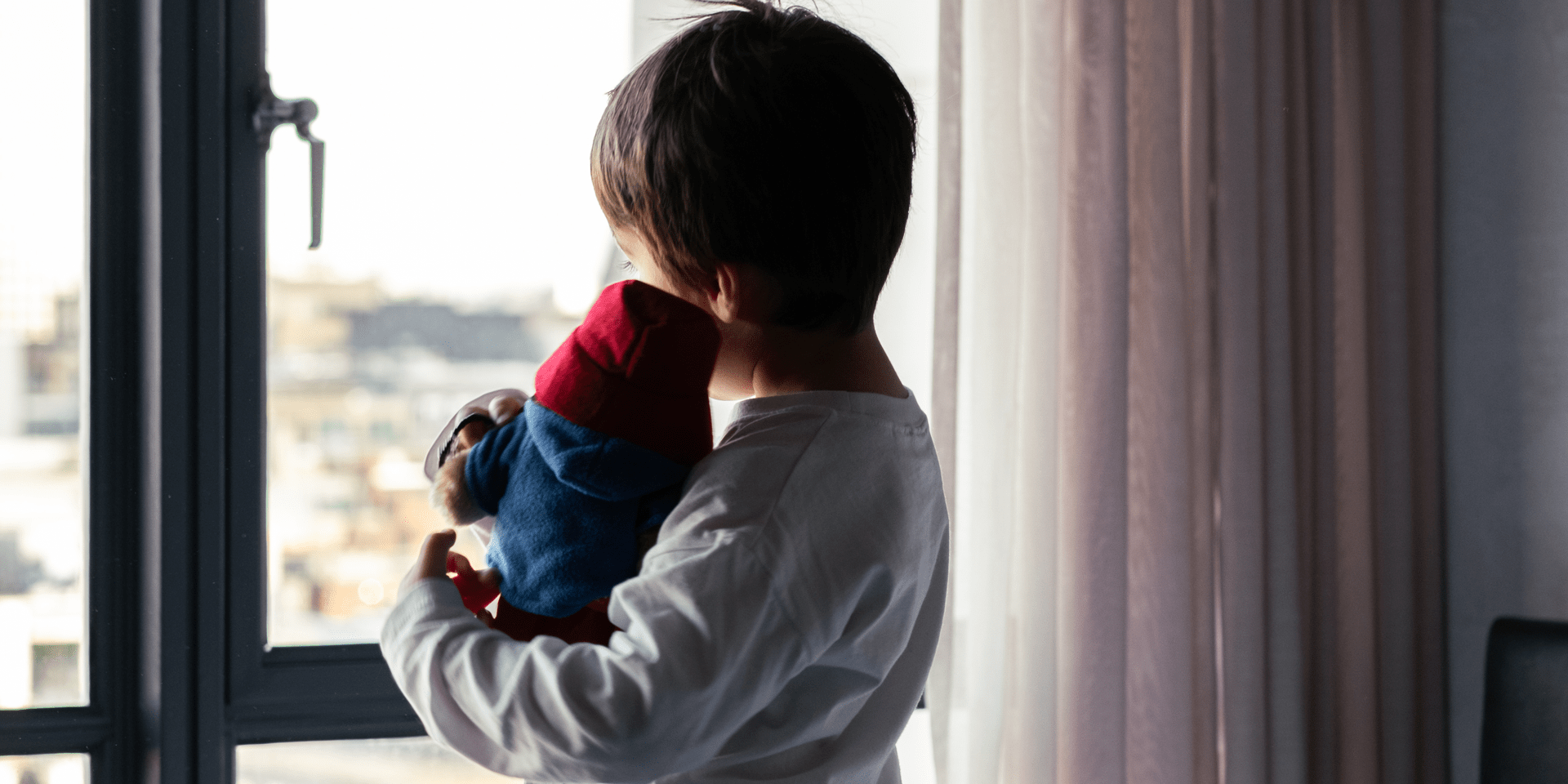 boy looking out window