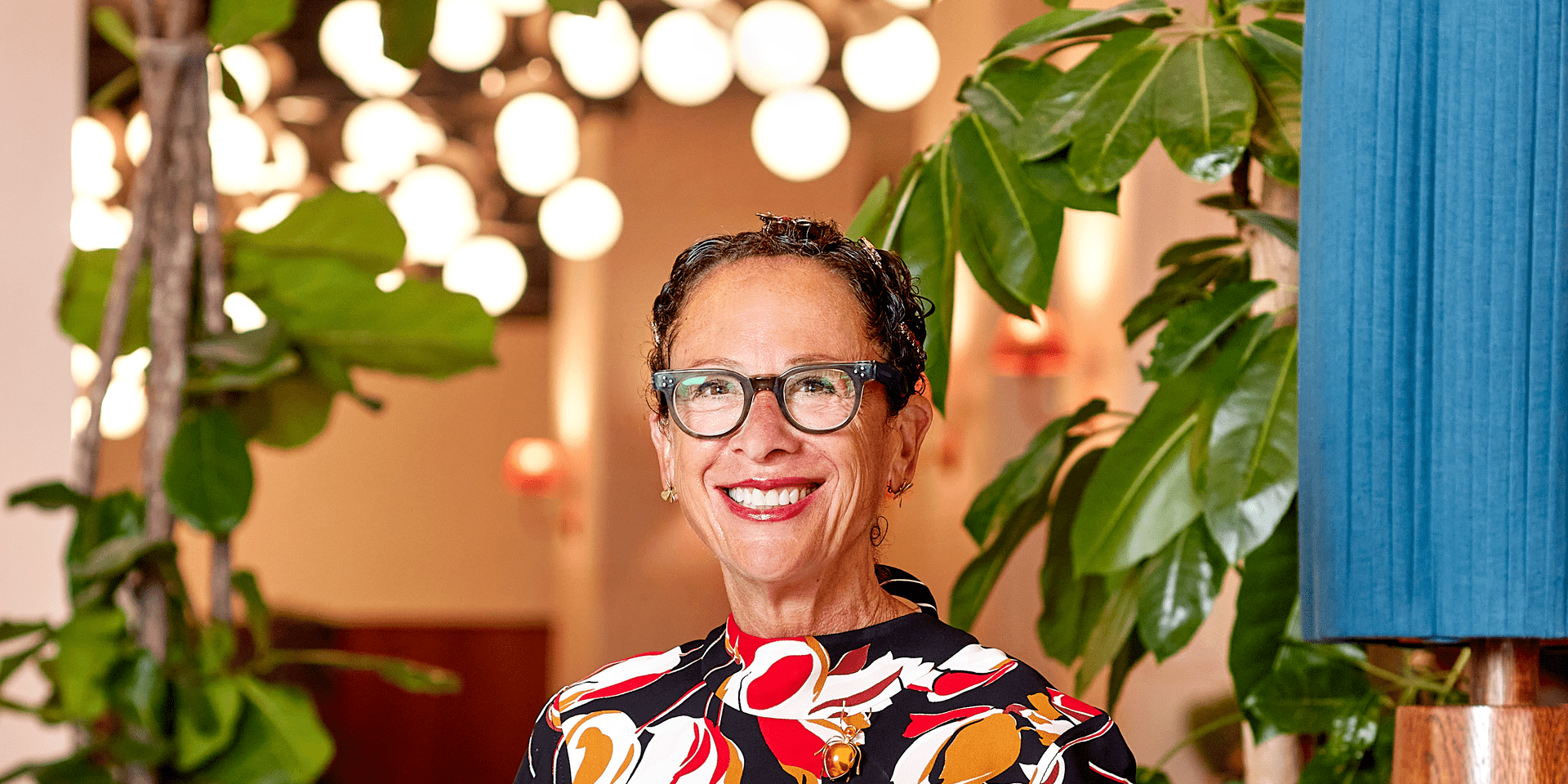 Nancy Silverton sitting on a chair posing for a photograph