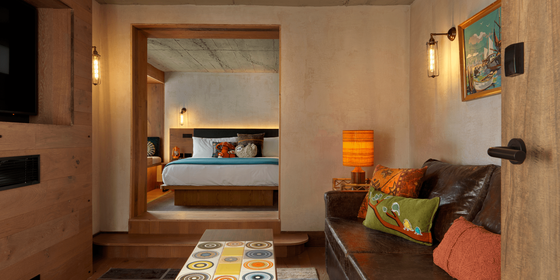 Looking into the bedroom through the living area of a suite in Treehouse London.