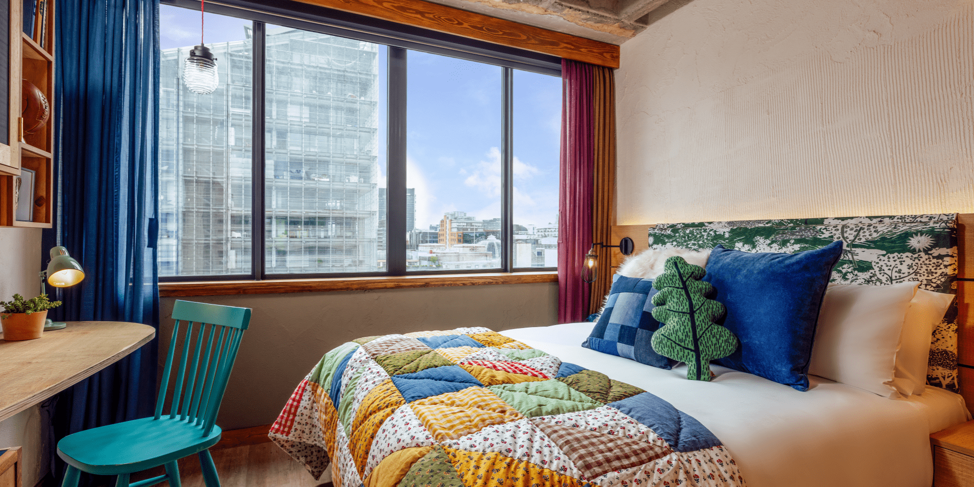 hotel room with king bed and view of skyline