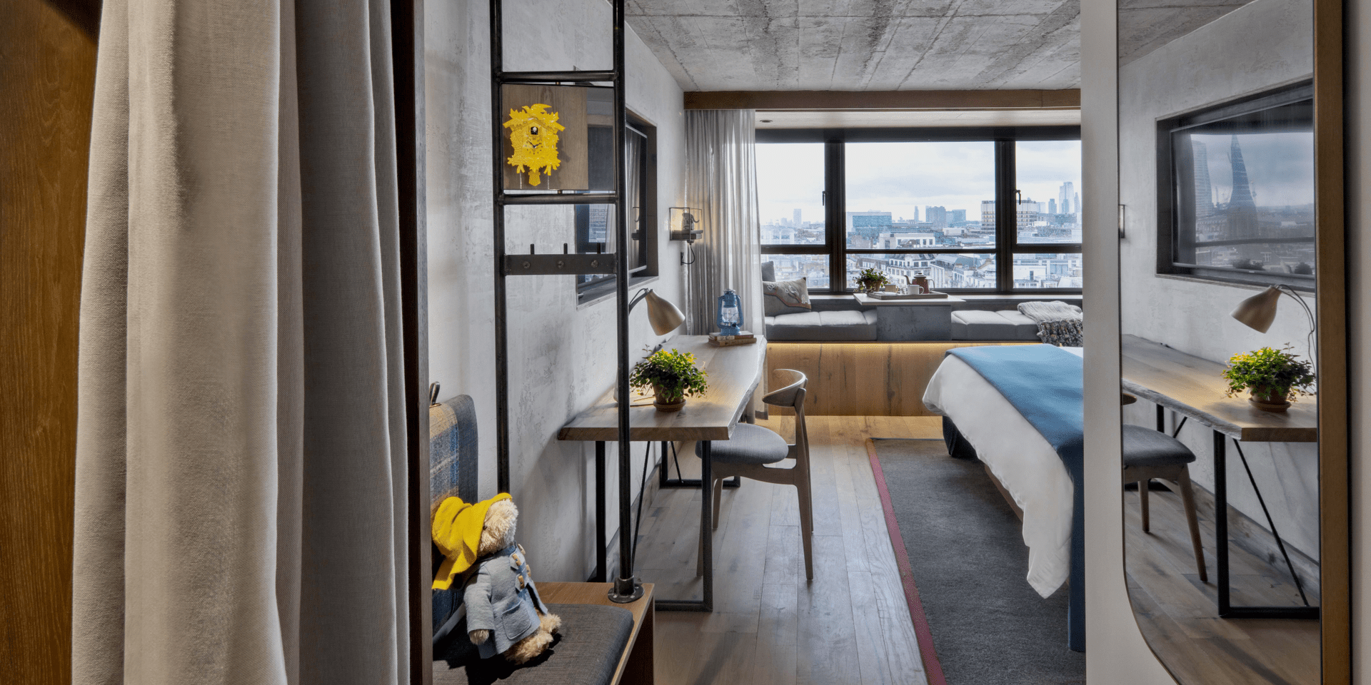 Entry way to hotel room with wardrobe and bench