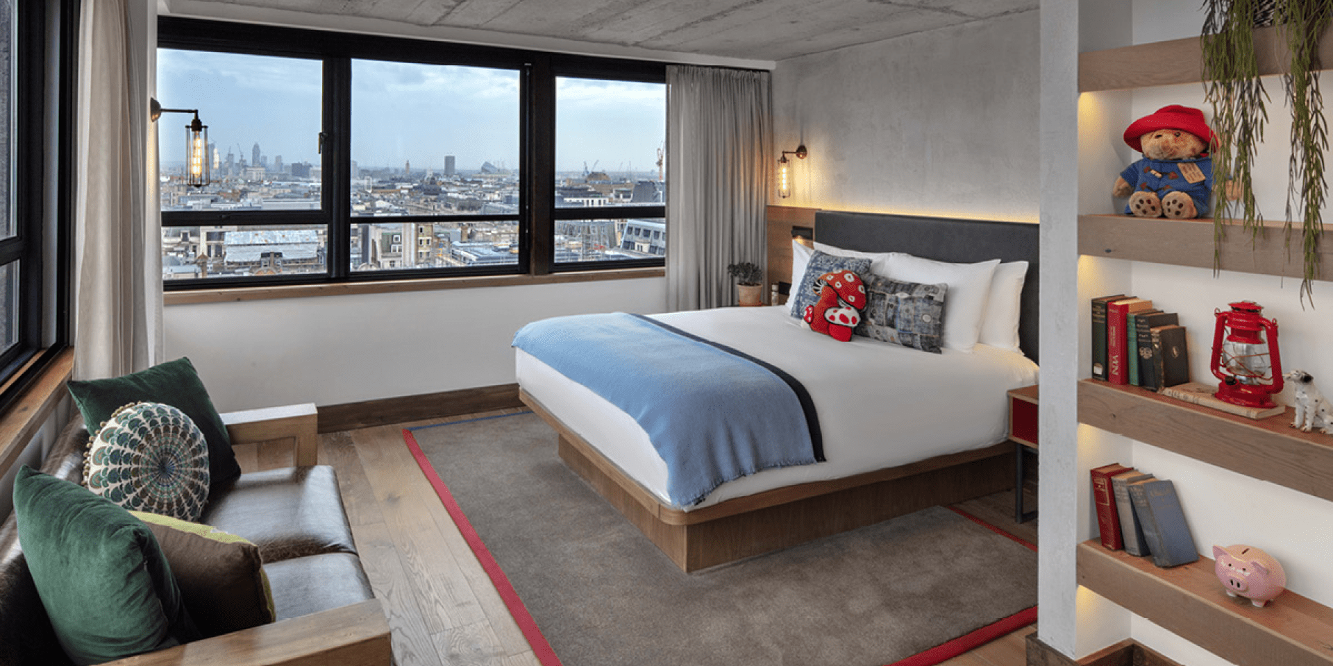 bedroom with queen bed, small seating area and a book case