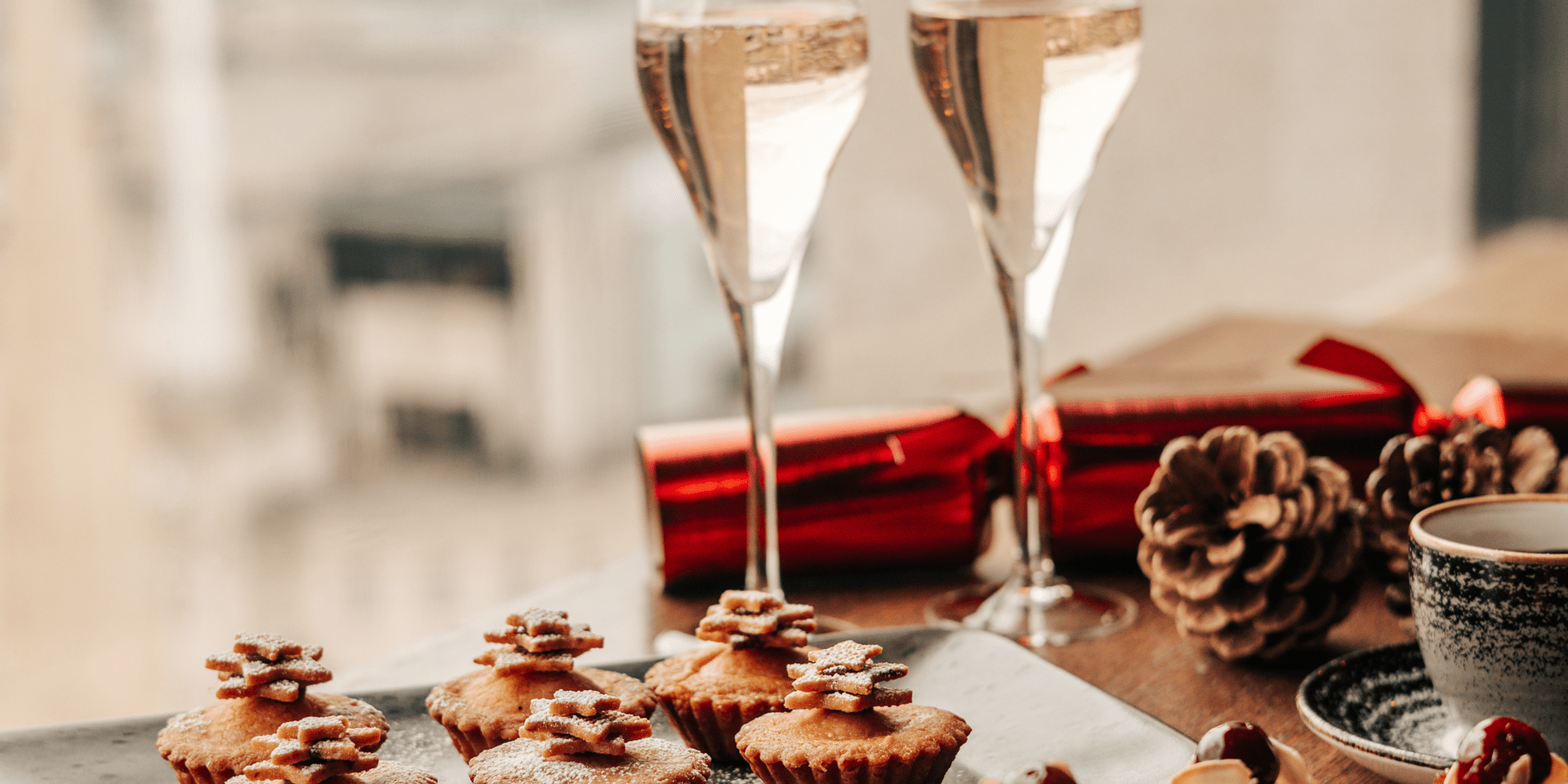 Christmas desserts next to two glasses of wine