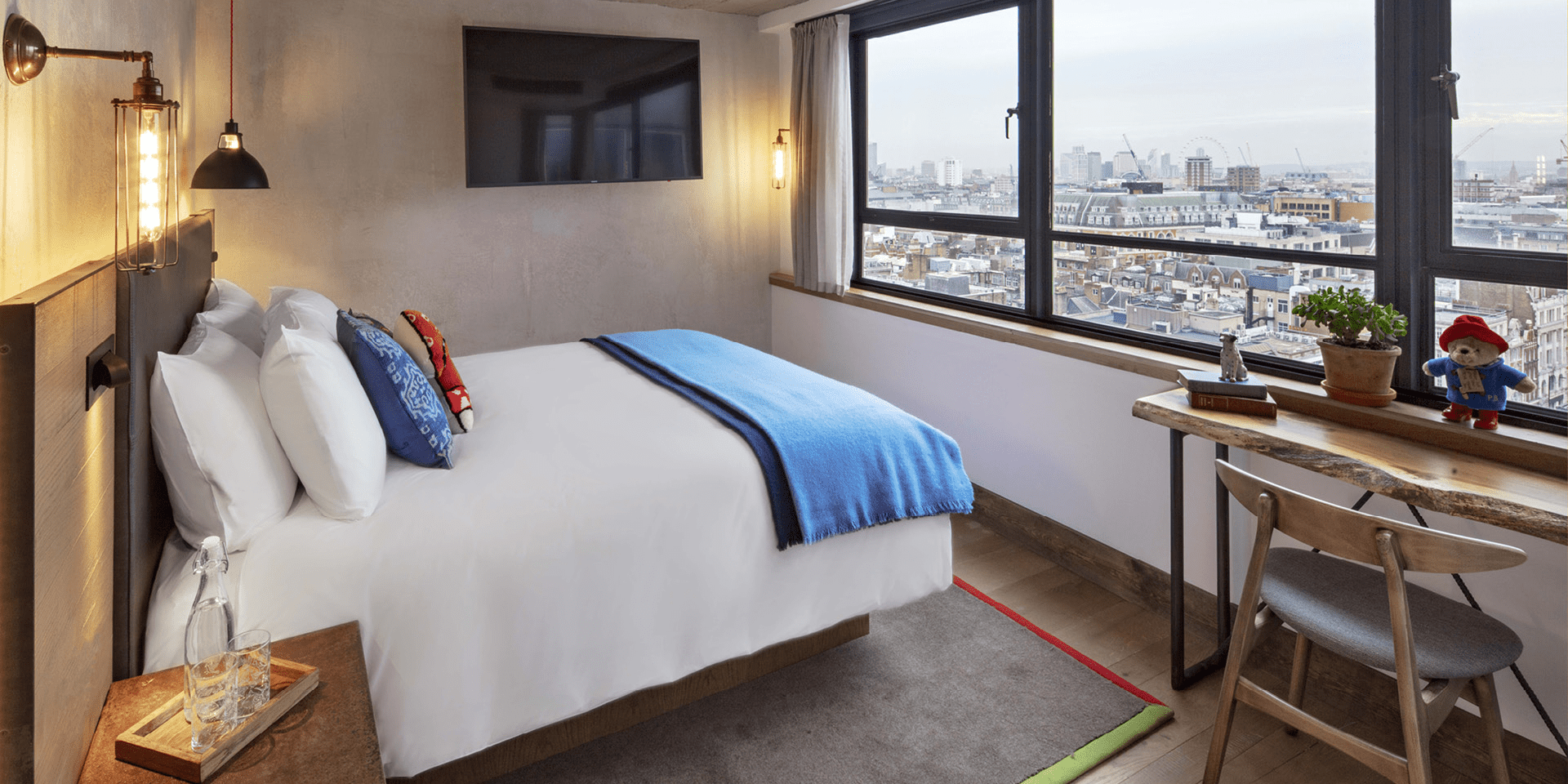 hotel room with queen bed and small workspace