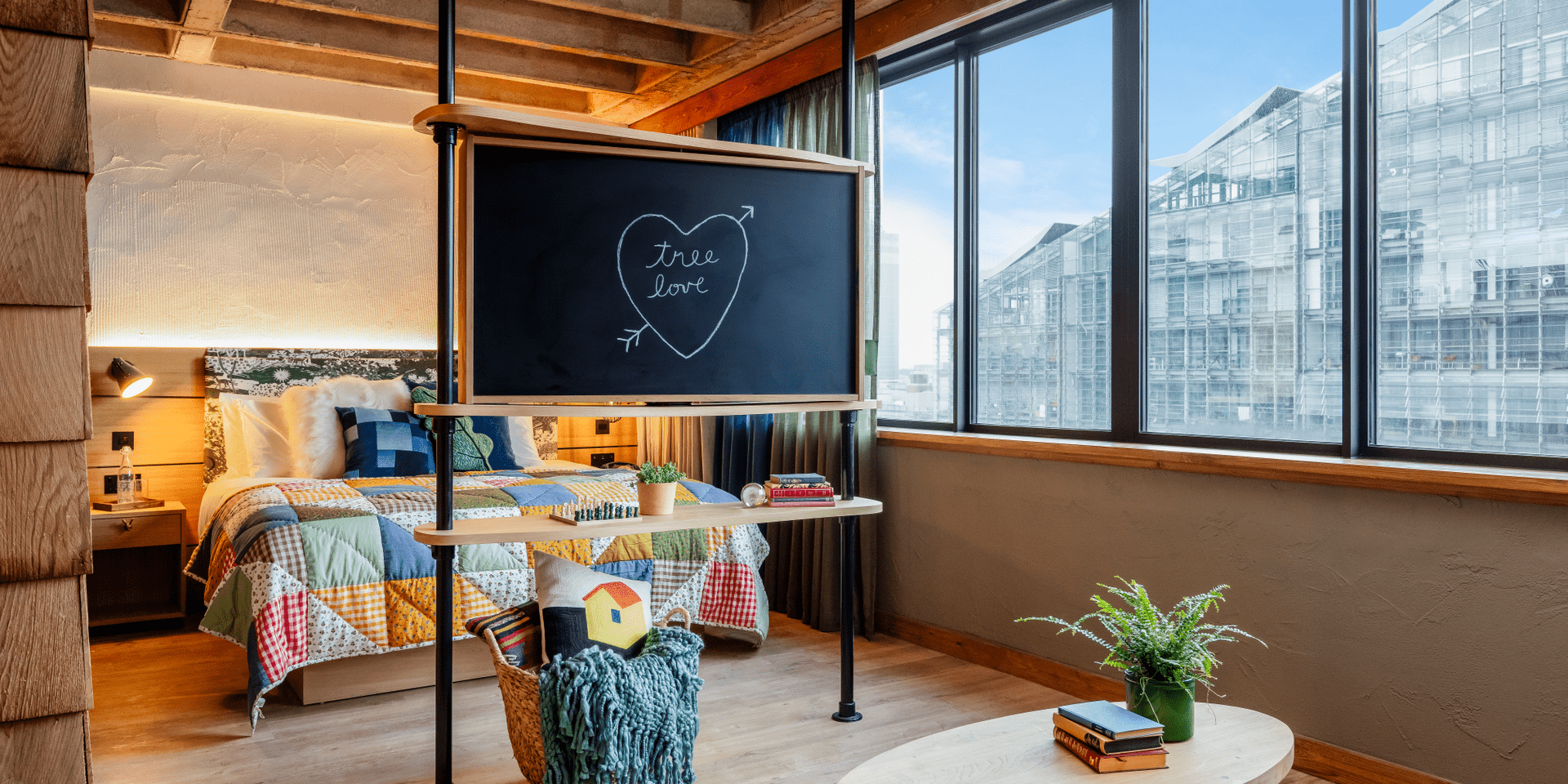 hotel room with bed and chalk board with Tree Love written in a heart