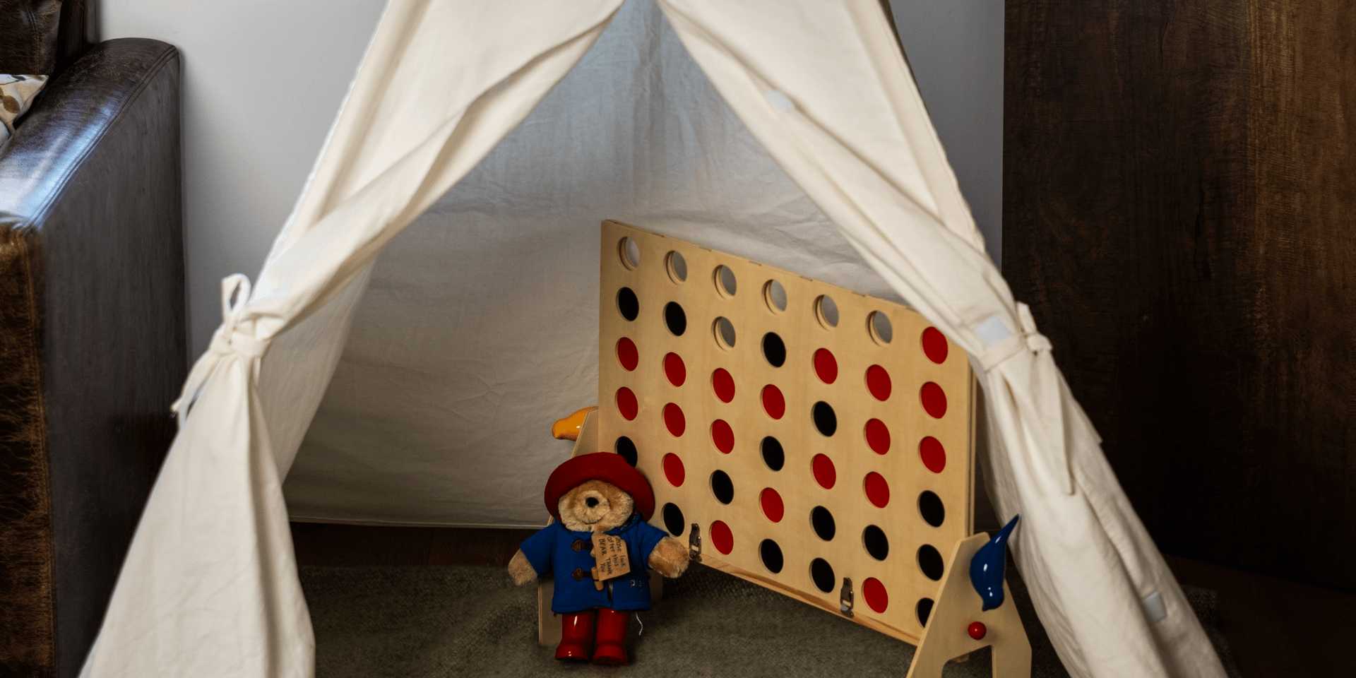 A children's tee-pee with connect four game set up inside at Treehouse Hotel.