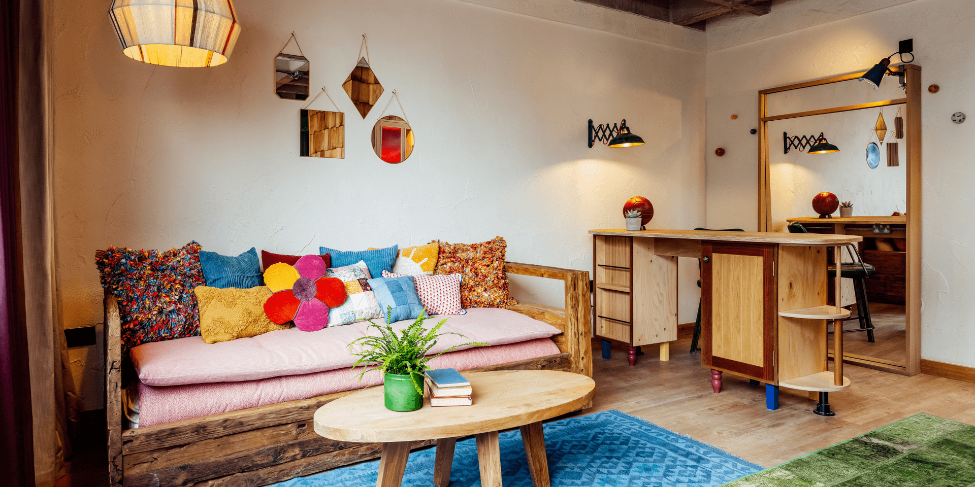 Sofa with various colourful pillows in seating area.