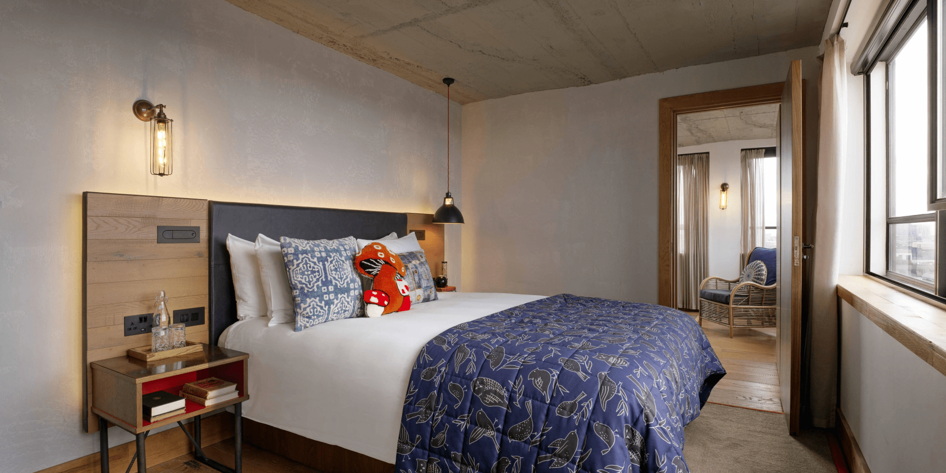 Hotel room with queen bed and view of living area