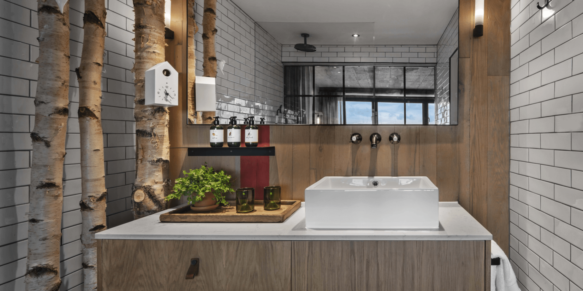 Bathroom with floating vanity and birch tree decor