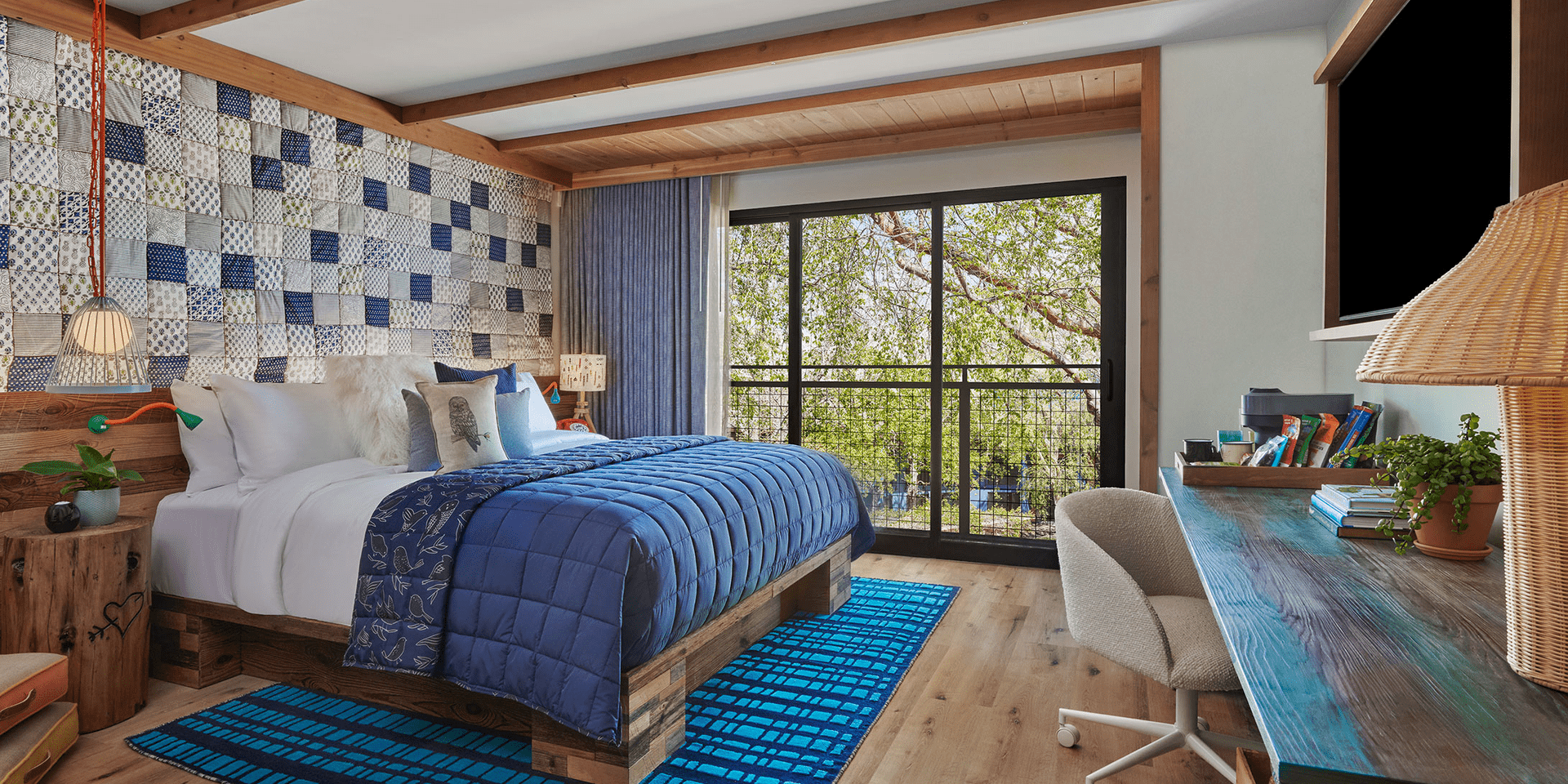 hotel room with king bed and large wood workspace