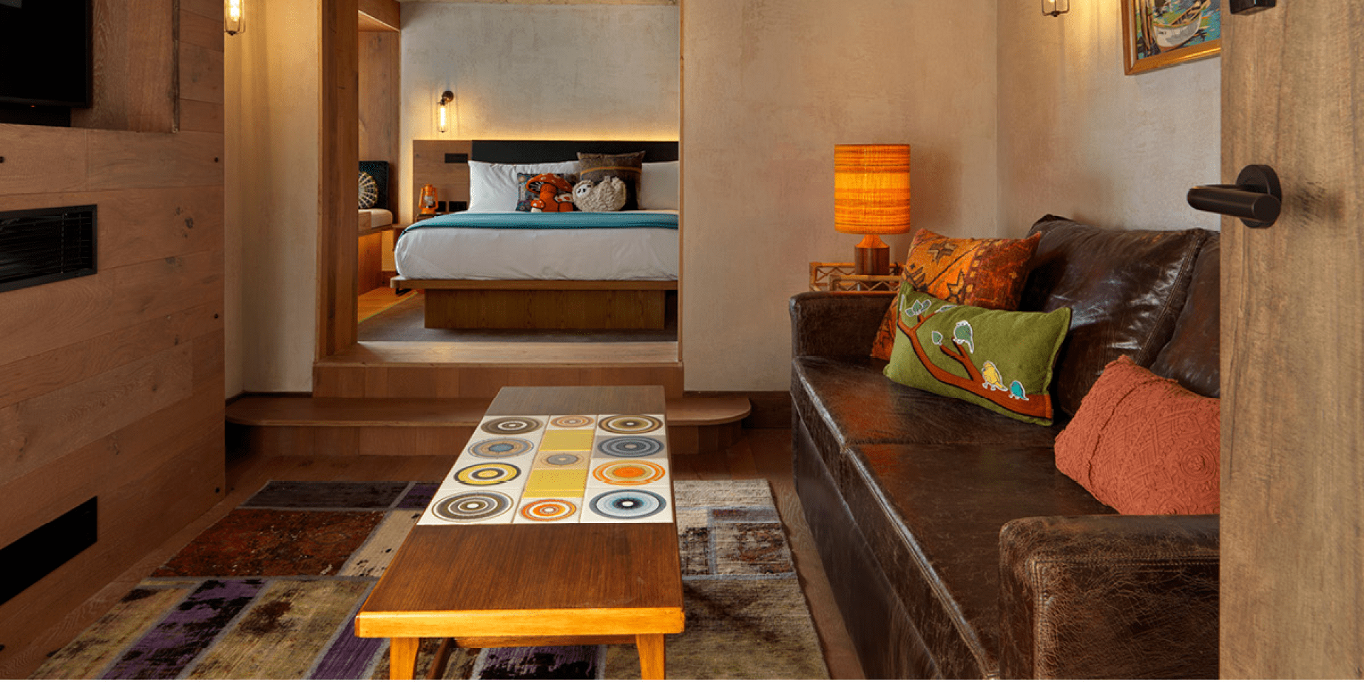 seating area with long table and wide doorway to bedroom