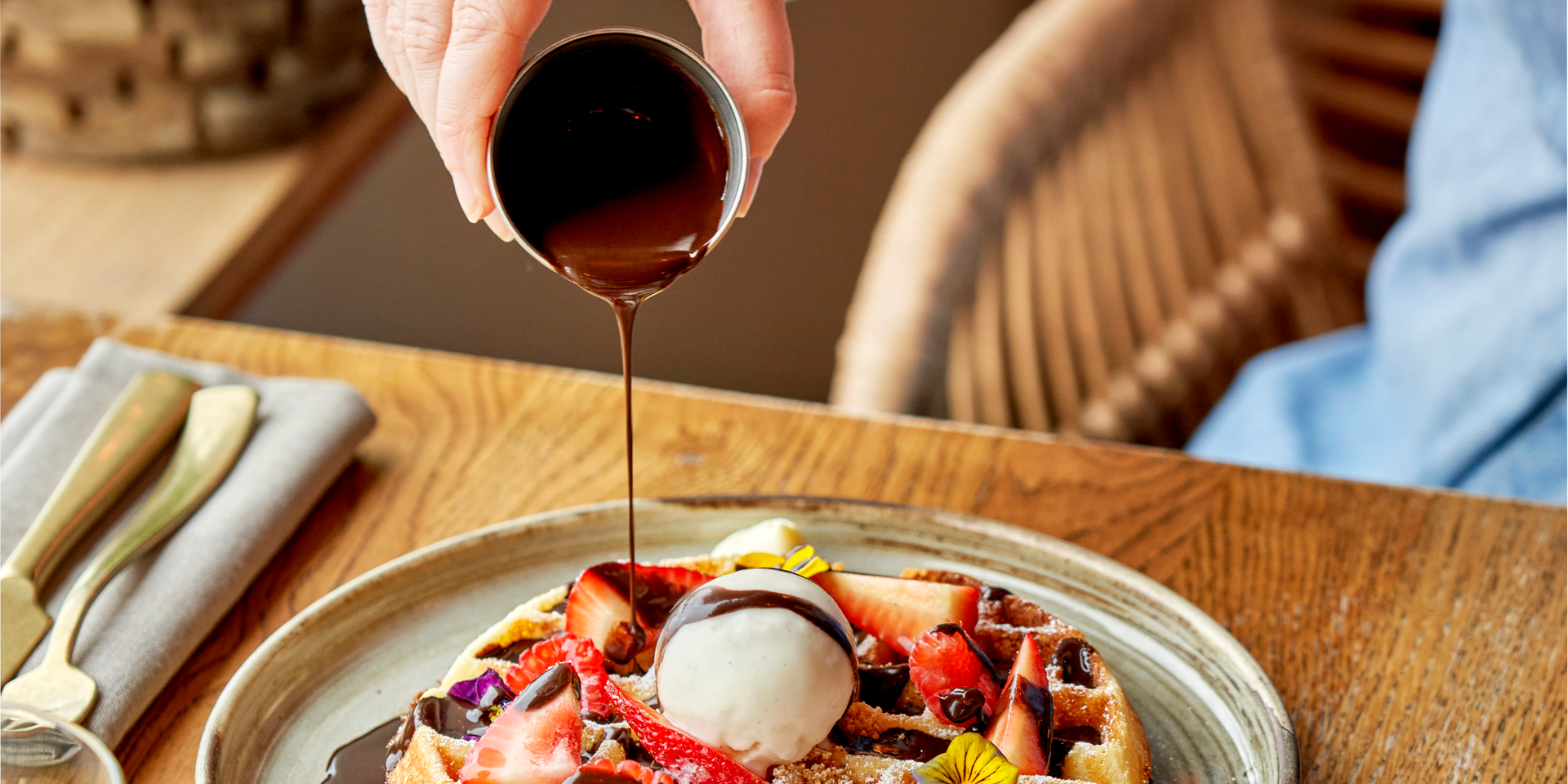 Pouring syrup on waffles
