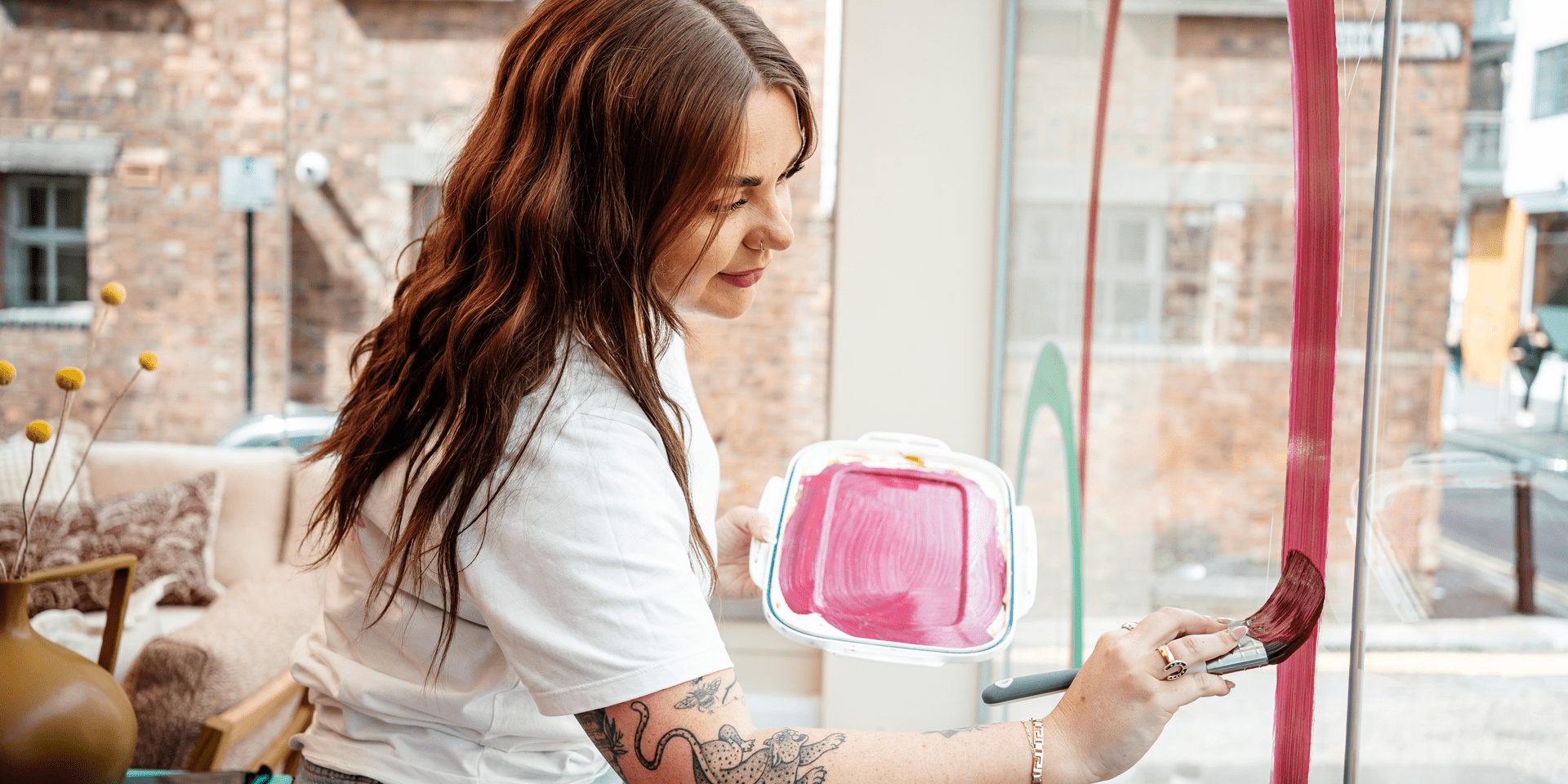 A woman painting a window