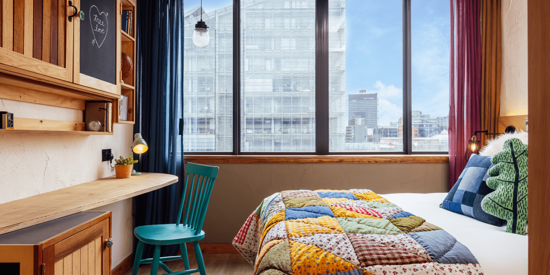 King bed next to large window in King Room of Treehouse Hotel Machester