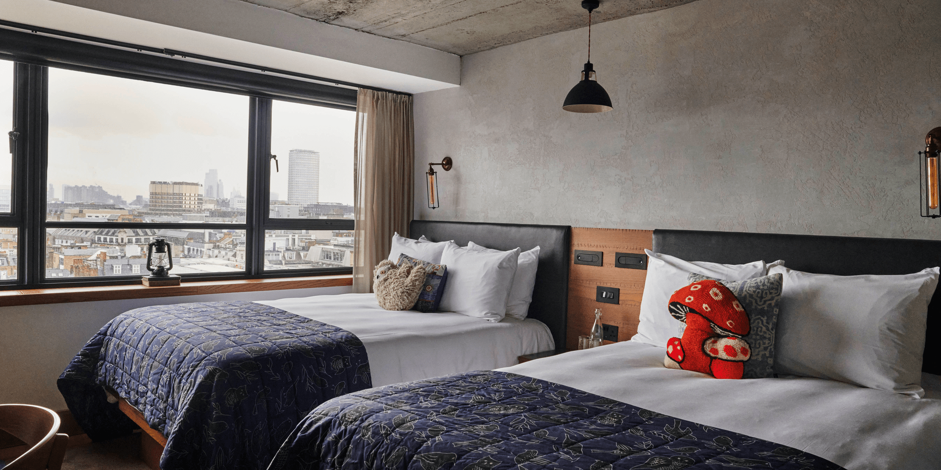hotel room with two twin beds and view of the city