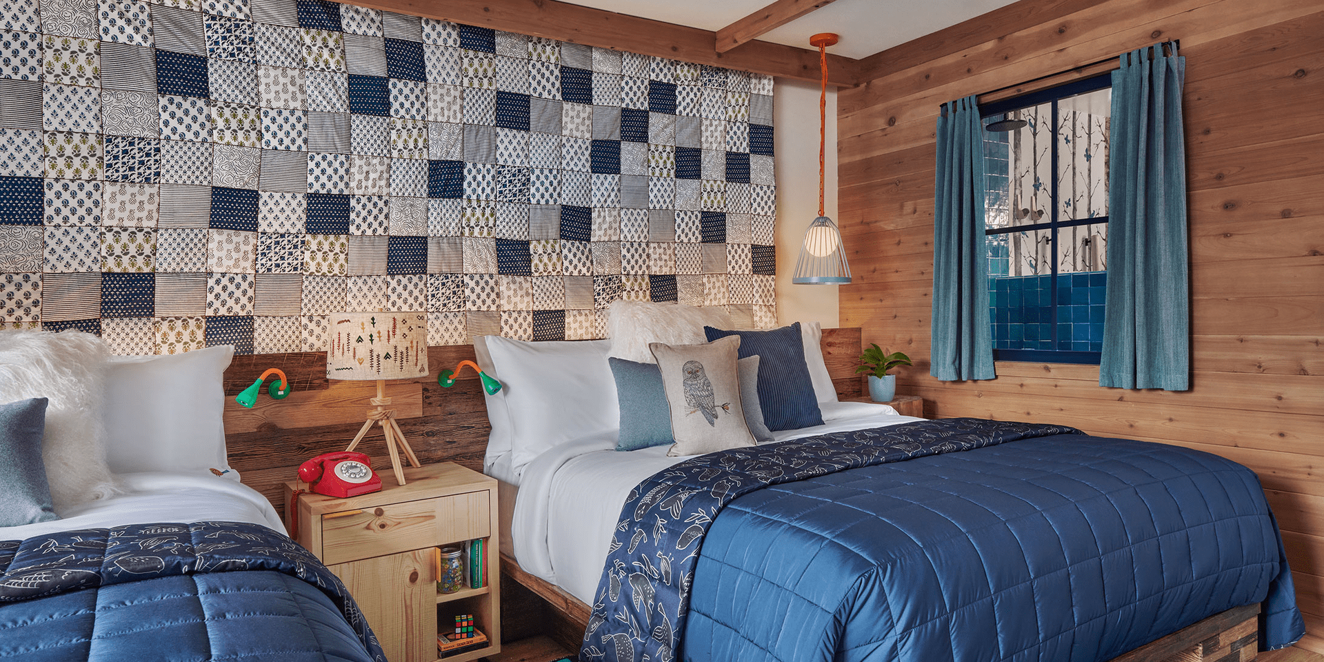 hotel room with two beds and quilted headboard