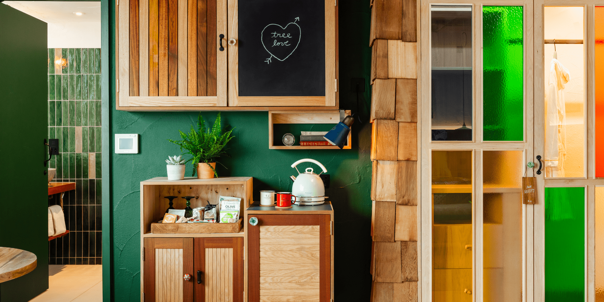 Hotel room with green walls and wood decor