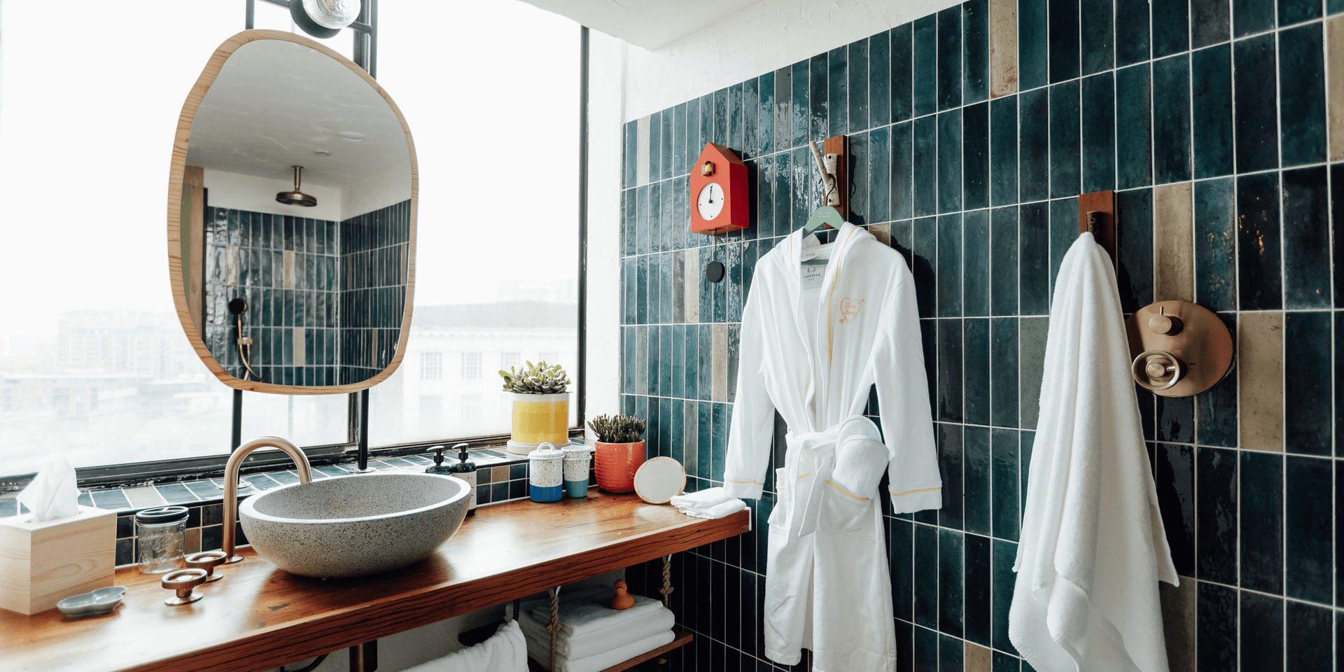 Bathroom with a long vanity and two robes hanging