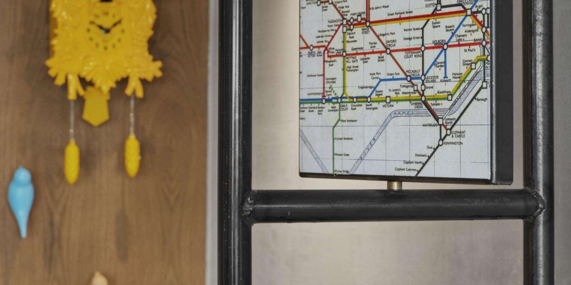 Coat hanger at entrance of room with a map of London on top