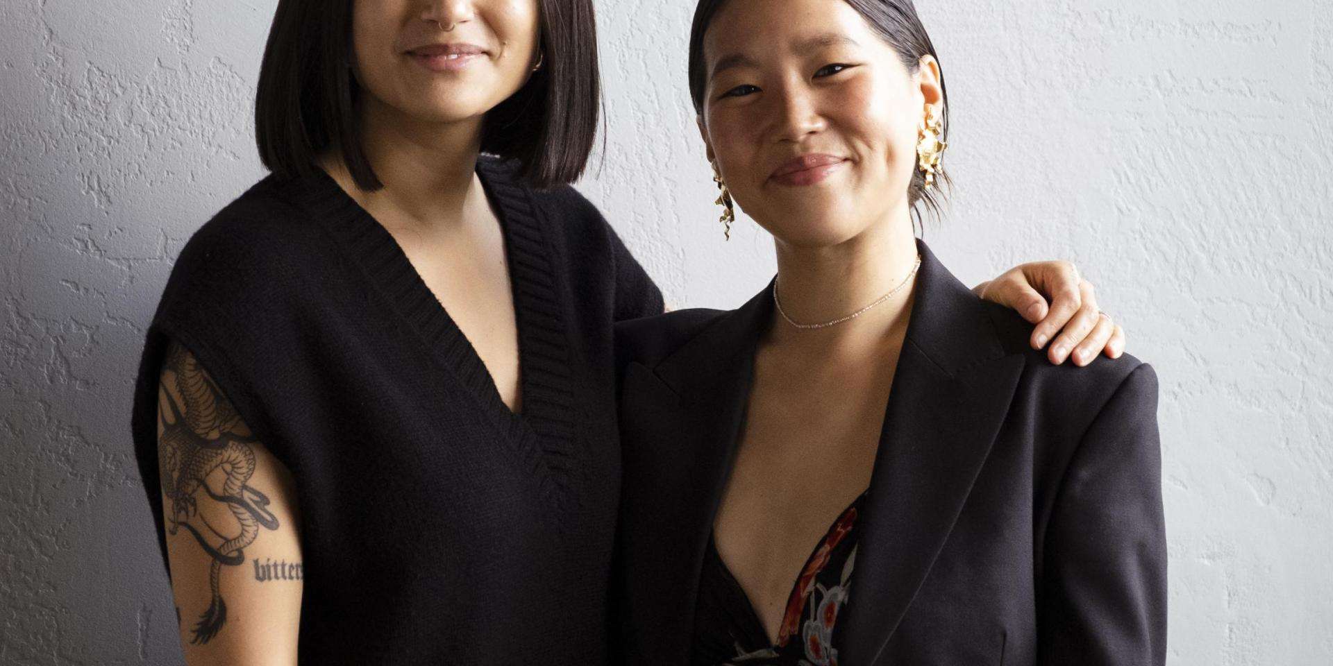 Two women in black posing
