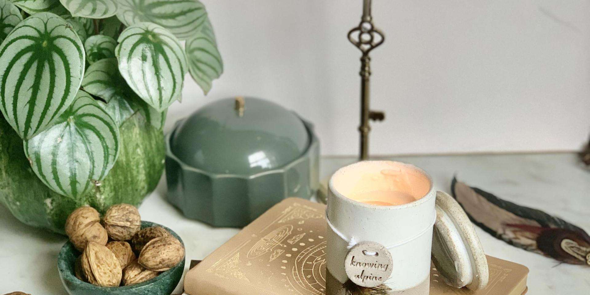 Womens Circle candle, feather, stack of old books