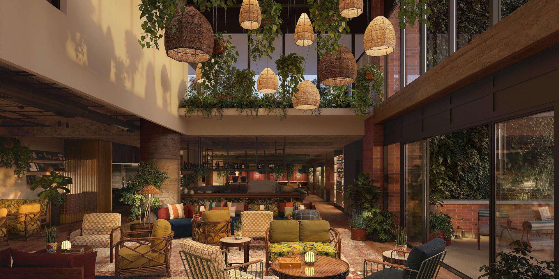 Hotel lobby featuring modern furniture, decorative plants, and a welcoming atmosphere for guests.